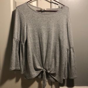 a cute loose grey shirt with a knot at the bottom